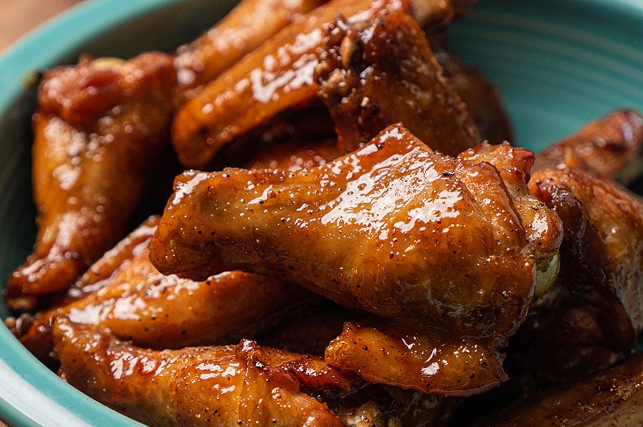 Sweet and sticky glazed wings in a turquoise bowl
